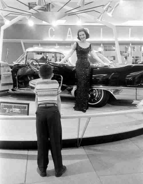 Cadillac and model at a 1957 car show